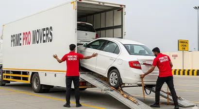Vehicle carrier parked on highway with movers loading cars using ramps during intercity transport