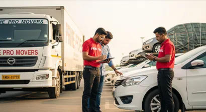 Team member inspecting a car before loading at a transport terminal with the customer in Punjab