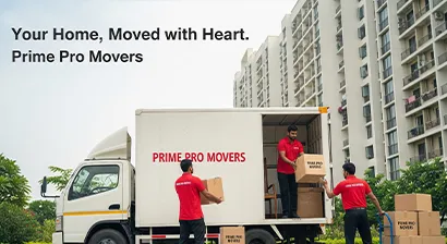 Movers loading household goods onto a moving truck outside a residential building in Punjab