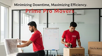 Movers packing office monitors and desk items during an office relocation in Punjab